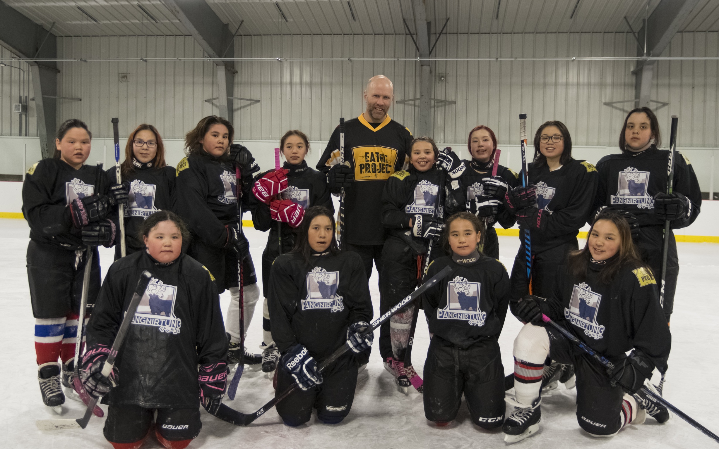 NHL Stanley Cup Champion Greg de Vries on the ice with Pangnirtung kids